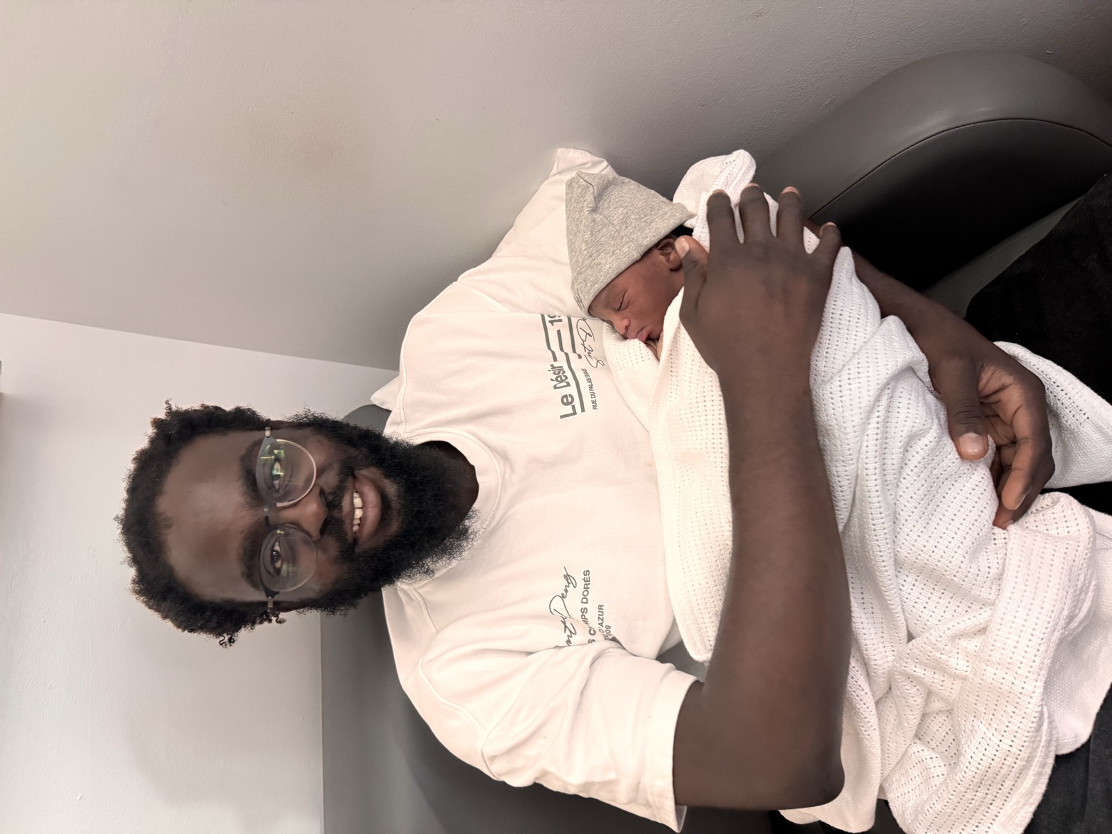 Proud dad David holding baby Shokunbi
